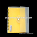 Yellow notebook with clear plastic cover with button closed